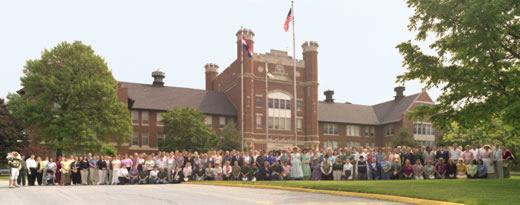 Staff and faculty at Northwest Missouri State University pose for a group picture in front of the Administration Building in 2005 during the campus Centennial celebrations.